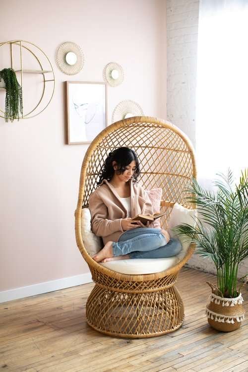 women sitting reading in egg chair