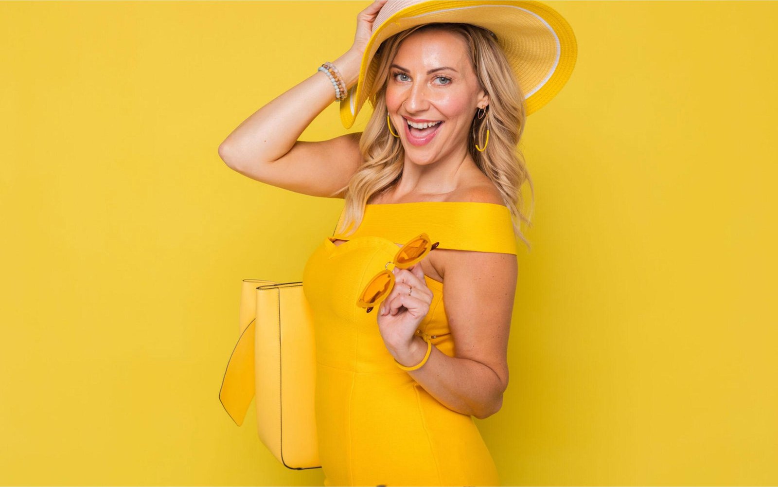 Woman in yellow dress and yellow backdrop